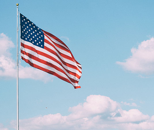 An American flag flying on a flag pole.