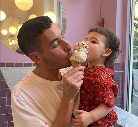 Elliot Tebele, founder of FJerryLLC, eating ice cream with his daughter.